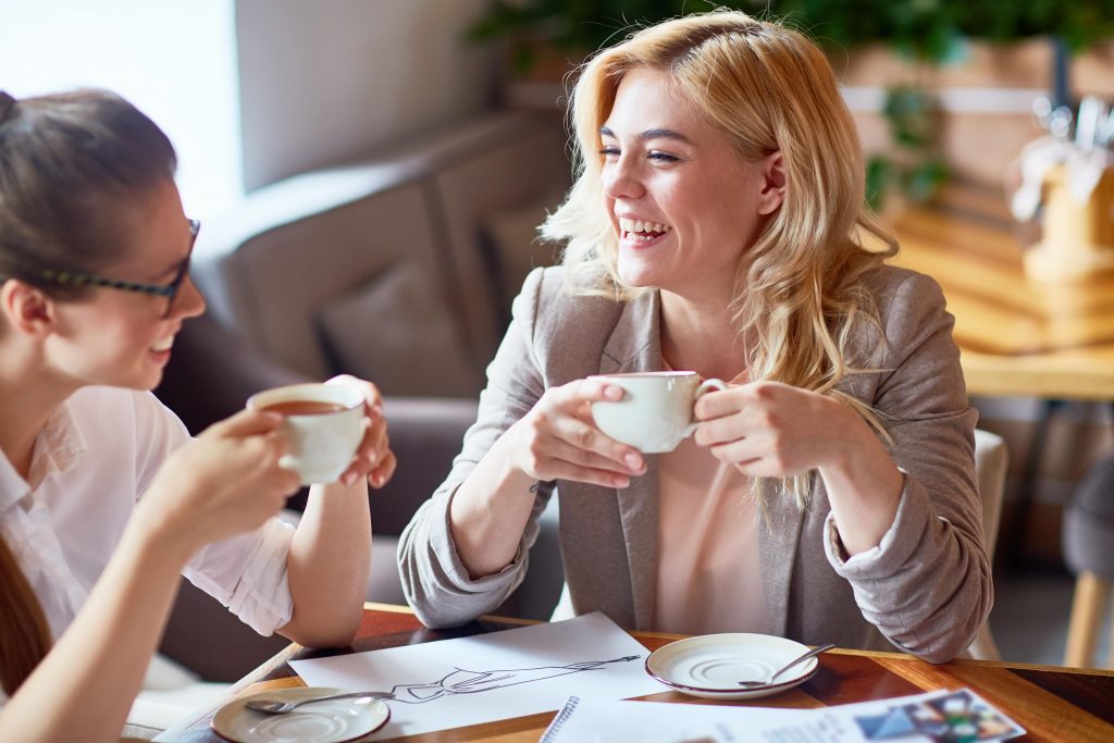 happy women bonding while drinking coffee